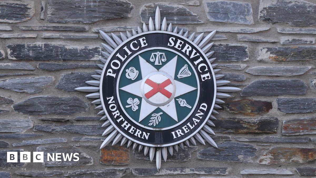 A PSNI logo on a brick wall