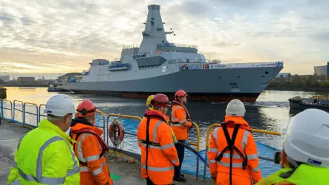 John Linton / BAE Systems via MoD HMS Glasgow makes its way to Scotstoun shipyard after being successfully floated on the Clyde.