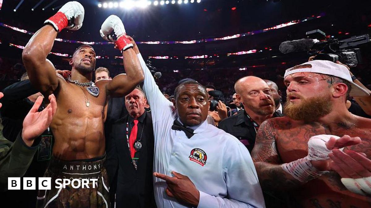 Anthony Joshua has his hand raised by the referee after beating Jake Paul by knockout in Miami