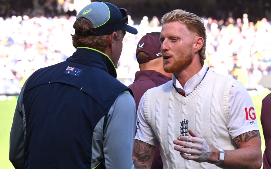England's captain Ben Stokes (R) shakes hands with Australia's coach Andrew McDonald (L) on the second day of the fourth Ashes cricket Test match between Australia and England at the Melbourne Cricket Ground (MCG).