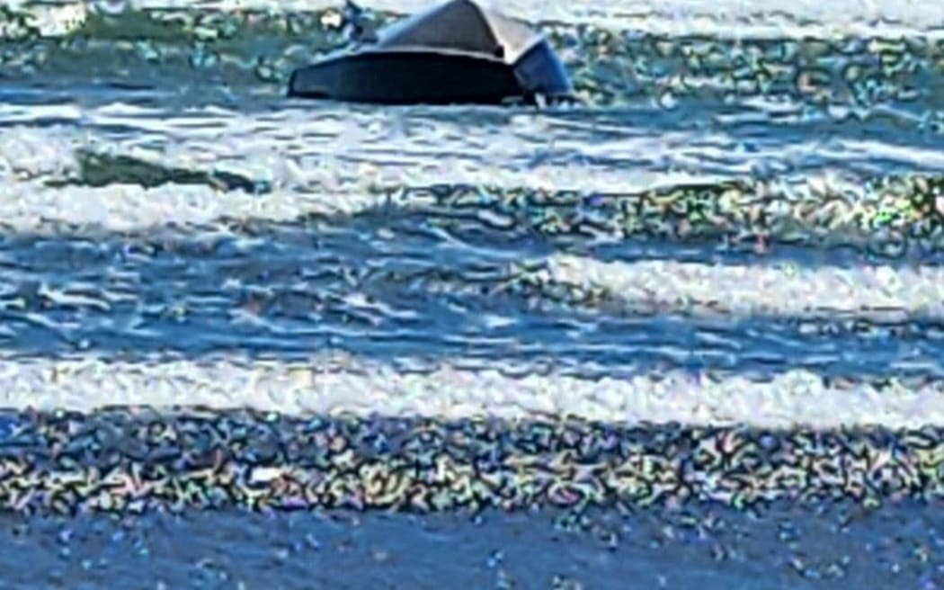 Darren Teague and his boat that capsized on the Raglan Bar on 1 November.