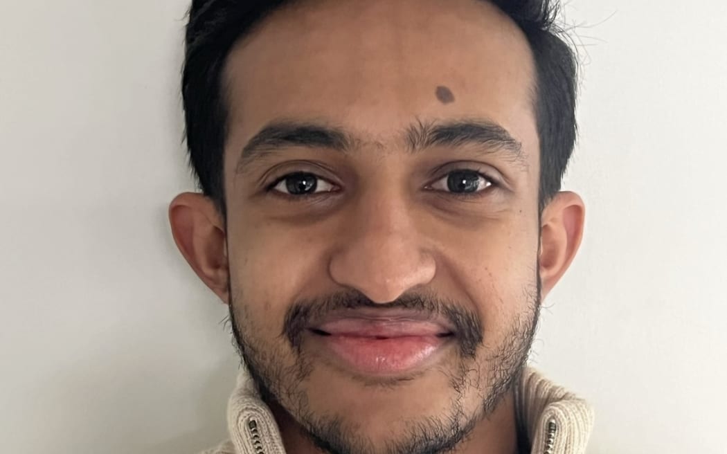 Photo of a man smiling at the camera.