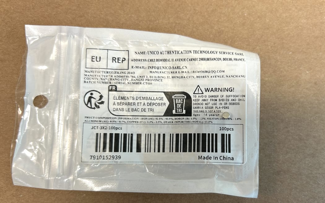 Photo of a mini magnet sitting on top of a packaging with warning labels.