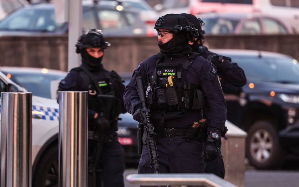 Armed police work at the scene after a shooting incident at Bondi Beach in Sydney on December 14, 2025. Australian police said two people were in custody following reports of multiple gunshots on December 14 at Sydney's famed Bondi Beach, urging the public to take shelter. (Photo by DAVID GRAY / AFP)
