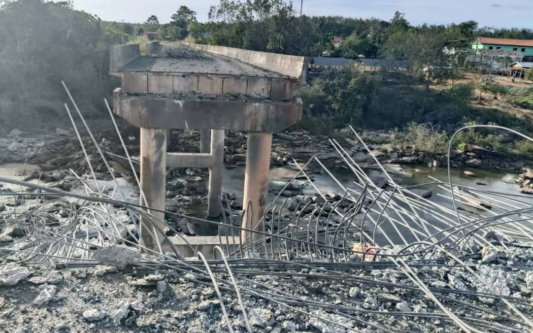 This handout photo taken and released by Agence Kampuchea Press (AKP) on December 13, 2025 shows a damaged bridge after Thai military strikes in Pursat province, amid clashes along the Cambodia-Thailand border. Violence between the Southeast Asian neighbours, which stems from a long-running dispute over the colonial-era demarcation of their 800-kilometre (500-mile) border, has displaced around half a million people on both sides. (Photo by AKP / Agence Kampuchea Press (AKP) / AFP) / RESTRICTED TO EDITORIAL USE - MANDATORY CREDIT 