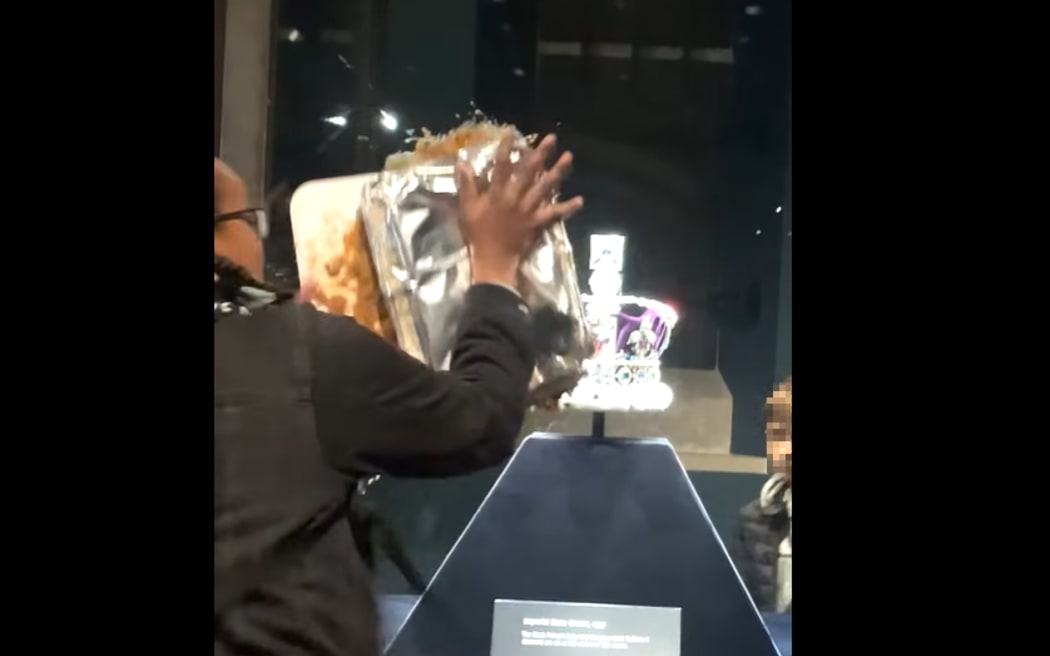 The group Take Back Power said two supporters smothered the custard dessert over the case containing the Crown Jewels to demand a citizen's assembly with the power to tax extreme wealth and "fix Britain".