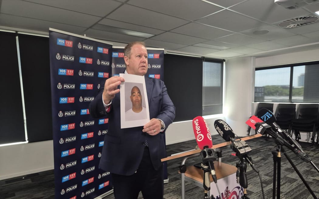 Police show a picture of Adrian Pani, 36, at a press conference after a fatal stabbing on an Auckland bus.