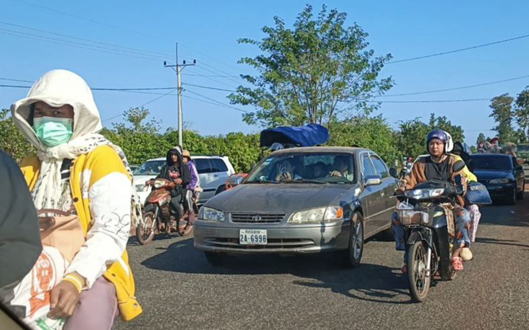 Local residents evacuate following clashes along the Cambodia-Thailand border in Preah Vihear province on December 8, 2025. A Thai soldier was killed and several others were wounded in fresh border clashes with Cambodia, Thailand's army said on December 8, 2025, with both sides trading blame for the latest eruption in fighting along their frontier. (Photo by -STR / AFP)