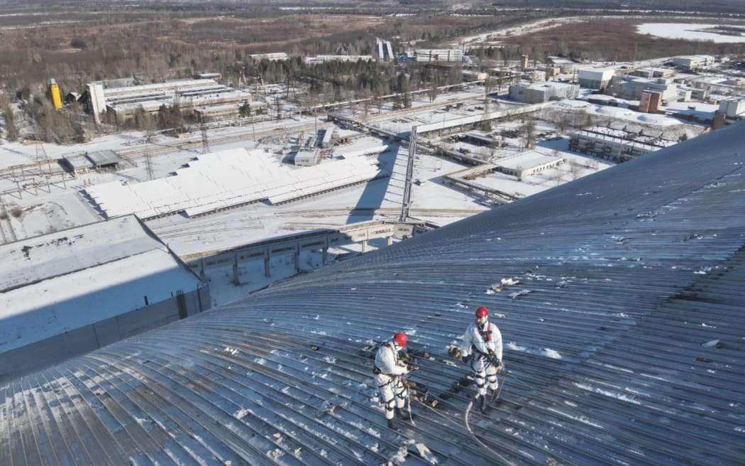 This handout photo released by Ukrainian Emergency Service on 17 February, 2025, shows the damaged containment vessel at the New Safe Confinement (NSC), which protects the remains of reactor 4 of the former Chernobyl Nuclear Power Plant to contain radiation, following a drone attack on 14 February, at Chernobyl.