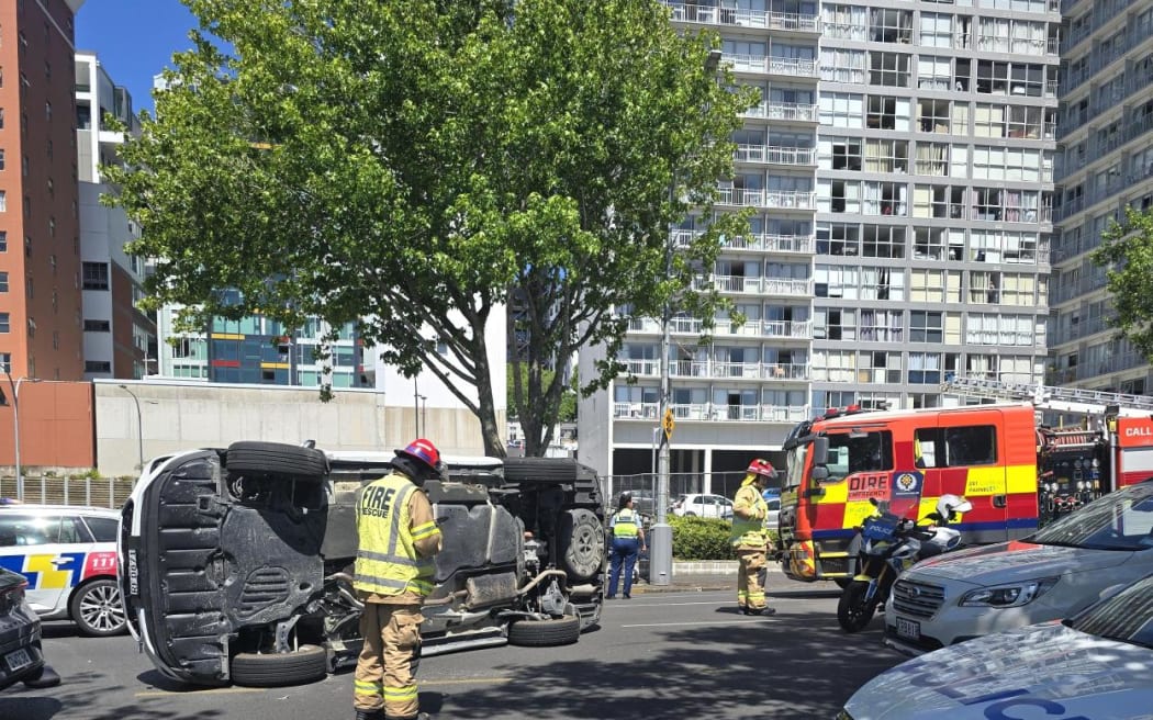 A car is on its side after a crash on Auckland's Nelson Street.