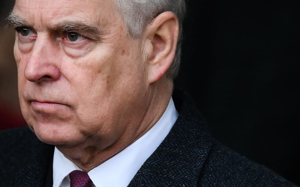 (FILES) Britain's Prince Andrew, Duke of York reacts as he leaves at the end of the Royal Family's traditional Christmas Day service at St Mary Magdalene Church in Sandringham, Norfolk, eastern England, on December 25, 2022. UK's scandal-hit Prince Andrew said on October 17, 2025, he is giving up his royal title. (Photo by Daniel LEAL / AFP)