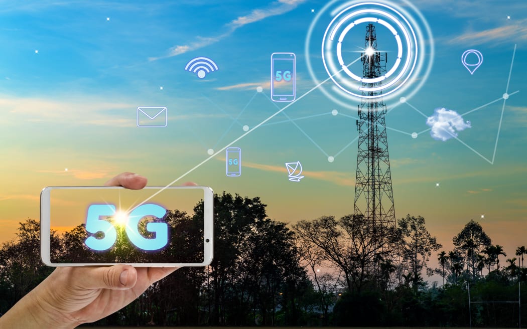 hand holding mobile smart phone using 5G network interface and icon