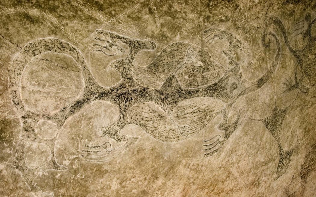 Ngāi Tahu rock art of three taniwha with their tails intertwined.