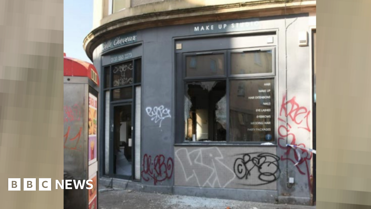 The fire-damaged Belle Cheveux salon has smashed windows and graffiti on the outside wals