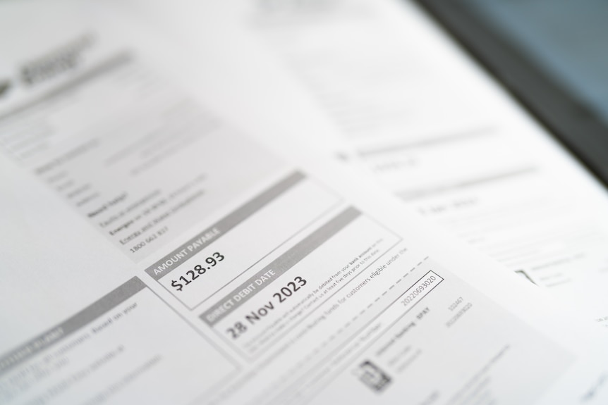 Black writing on a white piece of paper with blue reflections