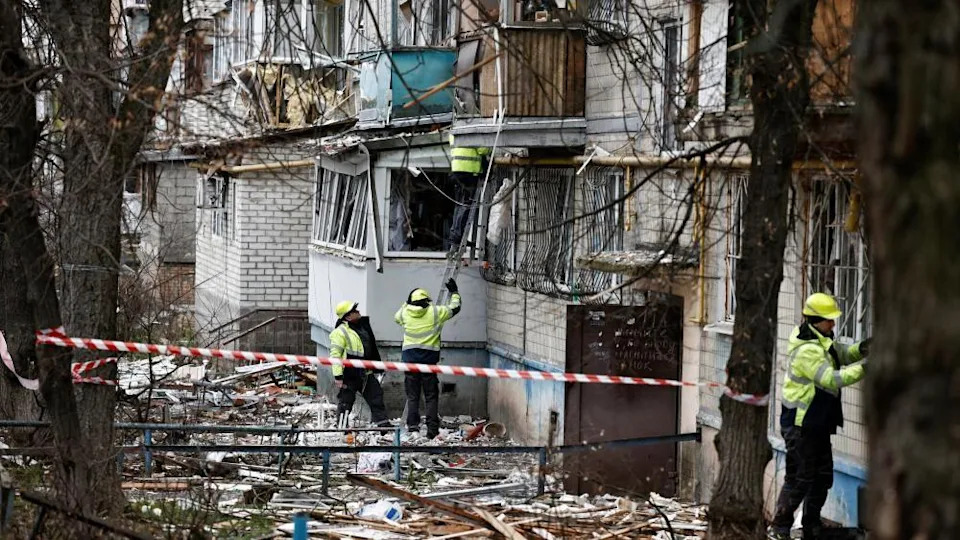 Emergency responders work at the site of a Russian drone strike on an apartment building