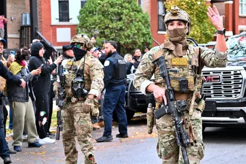 Getty Images Immigration and Customs Enforcement (ICE) agents conduct operations in the Little Village neighborhood, a predominantly Mexican American community in Chicago, United States on November 08, 2025. 
