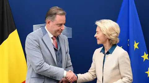 AFP European Commission President Ursula Von der Leyen (R) and Belgium's Prime Minister Bart de Wever shake hands prior to a meeting at the EU headquarters in Brussels on November 14, 2025