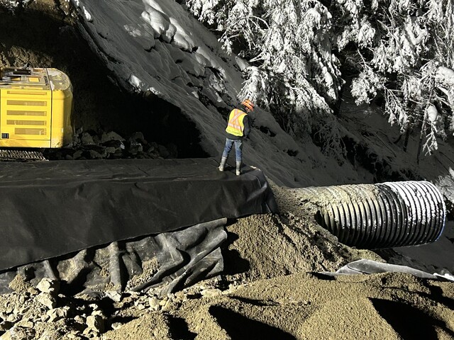 Crews work to repair a washout on Highway 3, east of Hope.