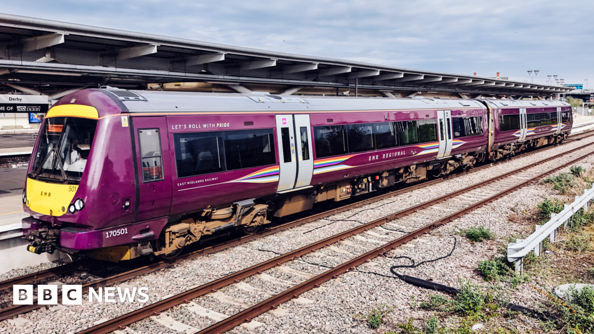 Purple train at a railway station platform