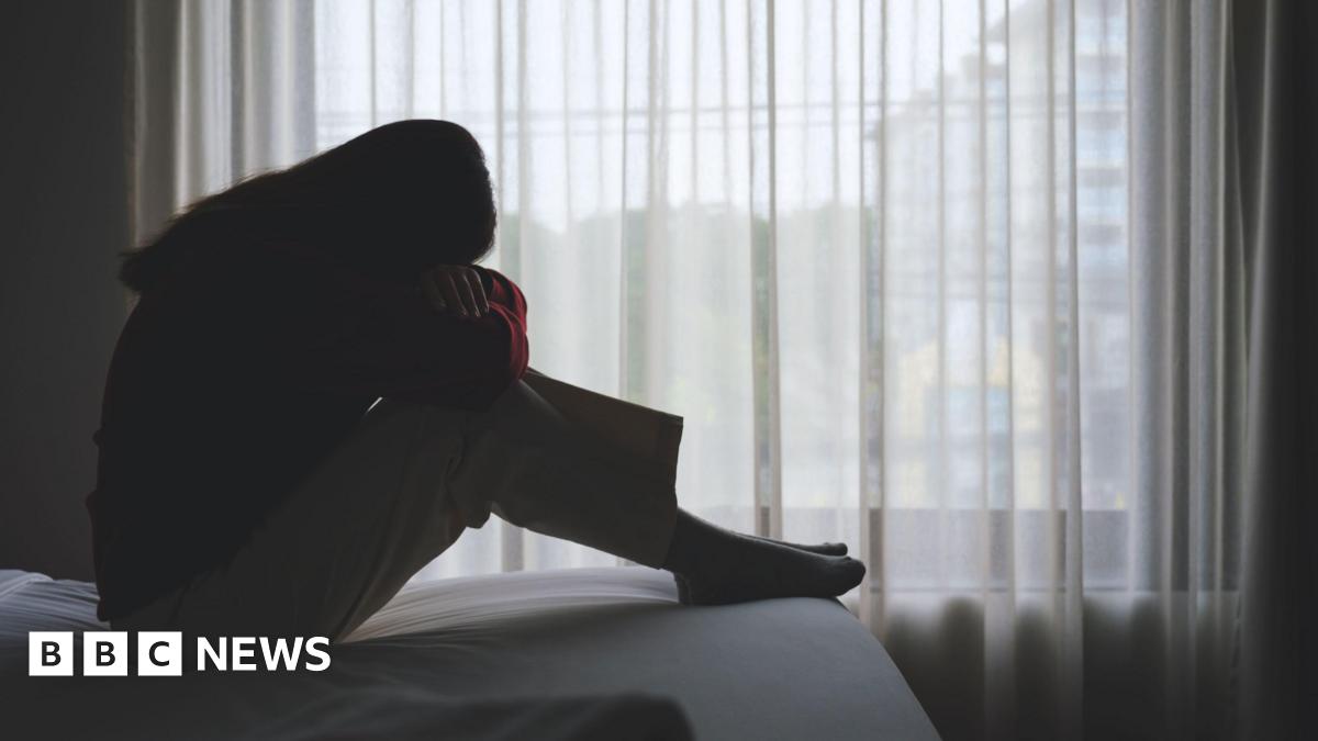 Bins overflowing with rubbish and bags of rubbish lying on the floor in heaps with rubbish spilling out of them.