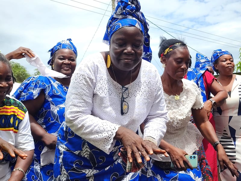 Nyamah Lablah, a community chairperson, celebrates the opening of a new well, made possible with donations from The Church of Jesus Christ of Latter-day Saints, on May 2, 2025, in Paynesville, Montserrado County, Liberia.