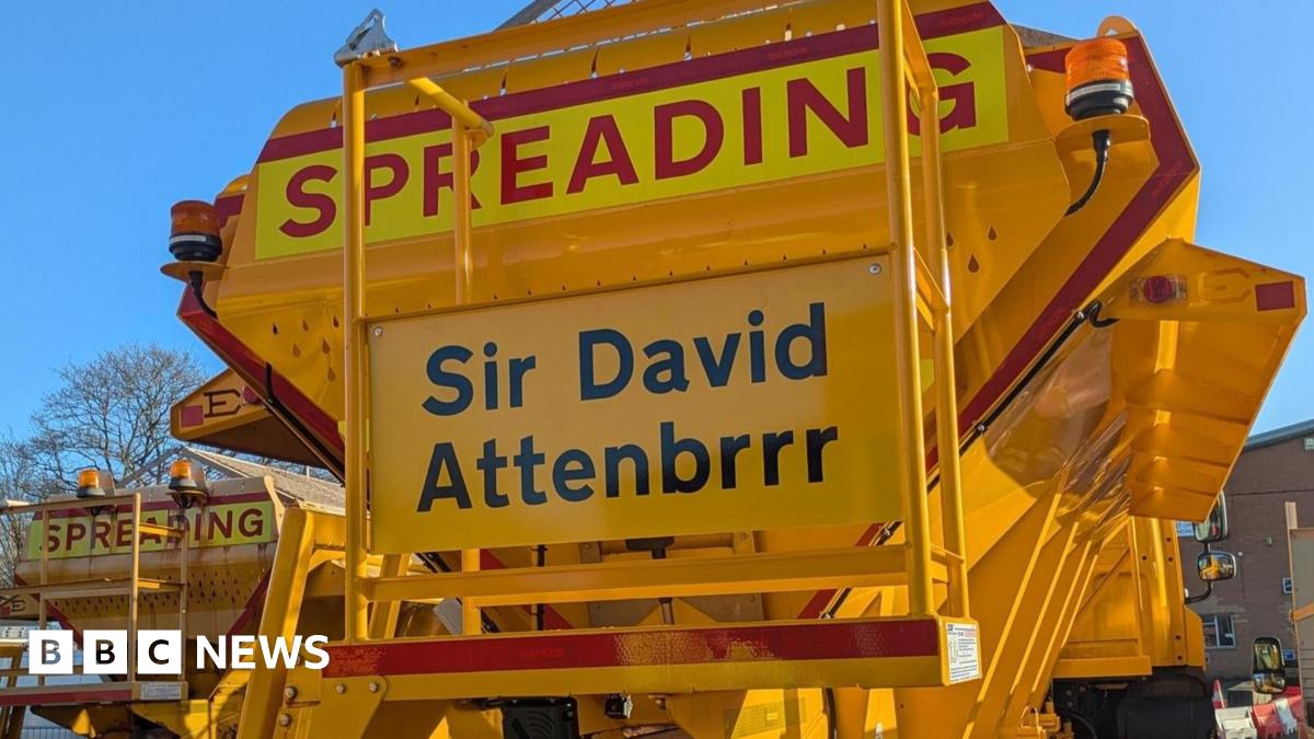 Yellow gritting vehicle with Sir David Attenbrrr on its rear.