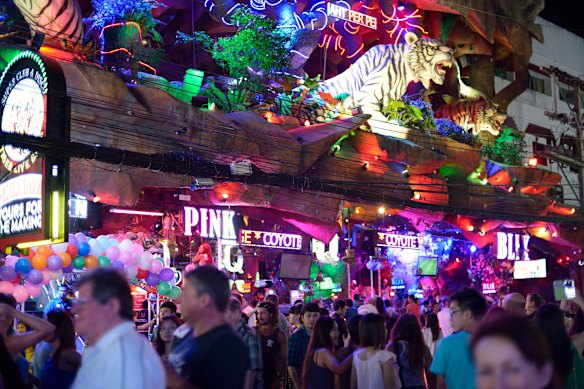 Popular tourist spots have turned into crowded strips full of neon signs. 
