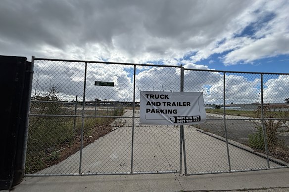 Public land locked up behind fences advertising truck and trailer parking.