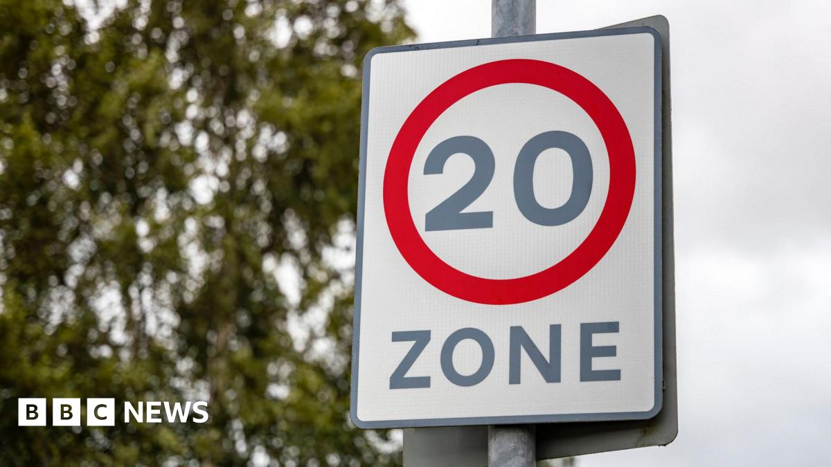 Red circle road safety suburban slow traffic calming sign with 20mph speed limit restriction zone street sign - stock photo