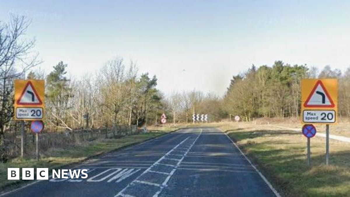 View of the A170 at the top of Sutton Bank, with max speed 20 warning signs