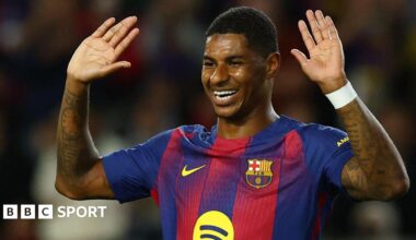 Marcus Rashford holds his hands up in celebration after scoring for Barcelona