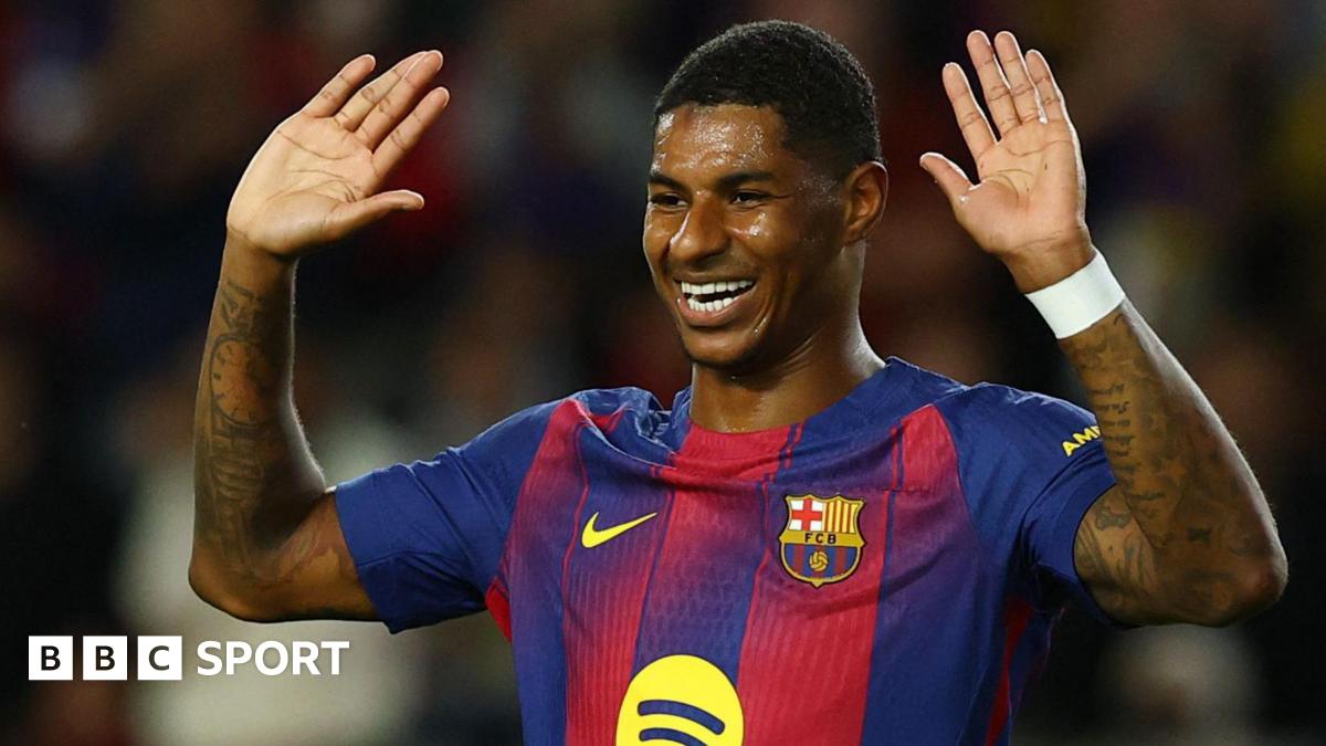 Marcus Rashford holds his hands up in celebration after scoring for Barcelona