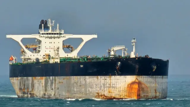 An oil tanker with a black and white hull and white superstructure
