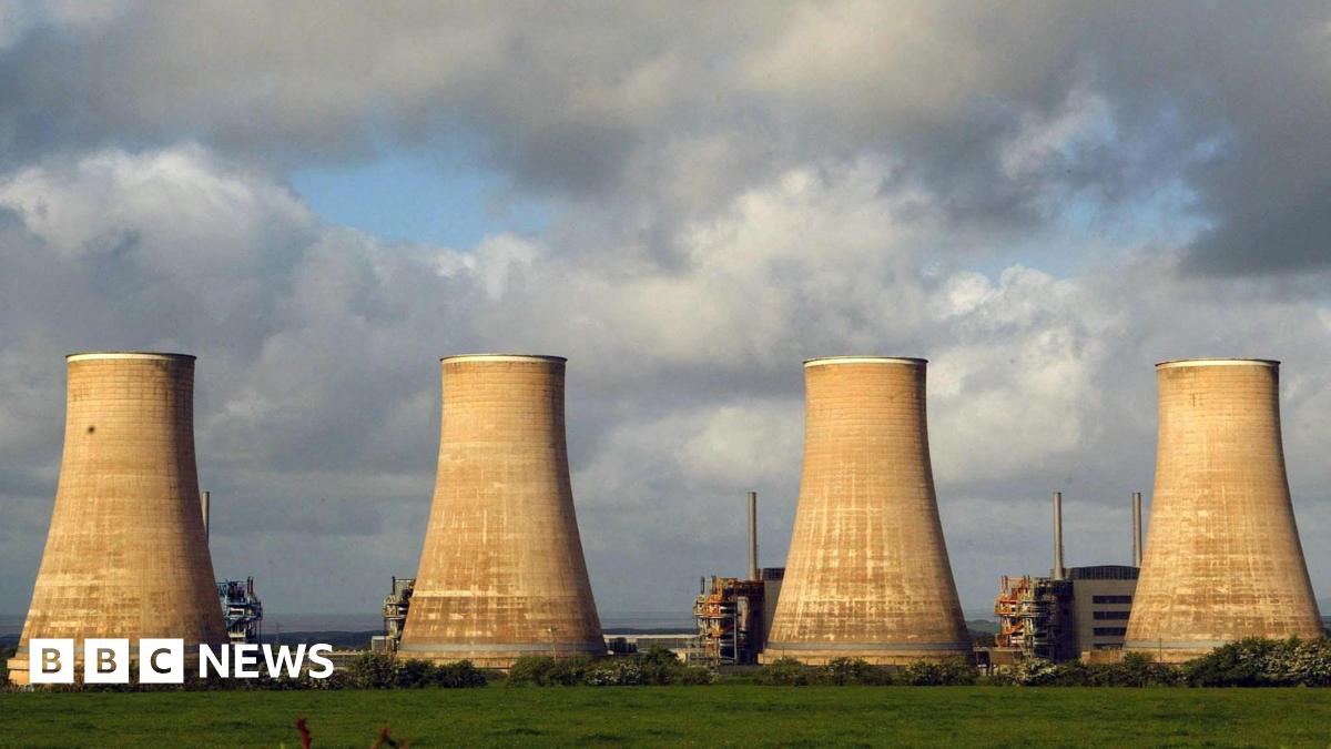 Four nuclear power station cooling towers against a cloudy background