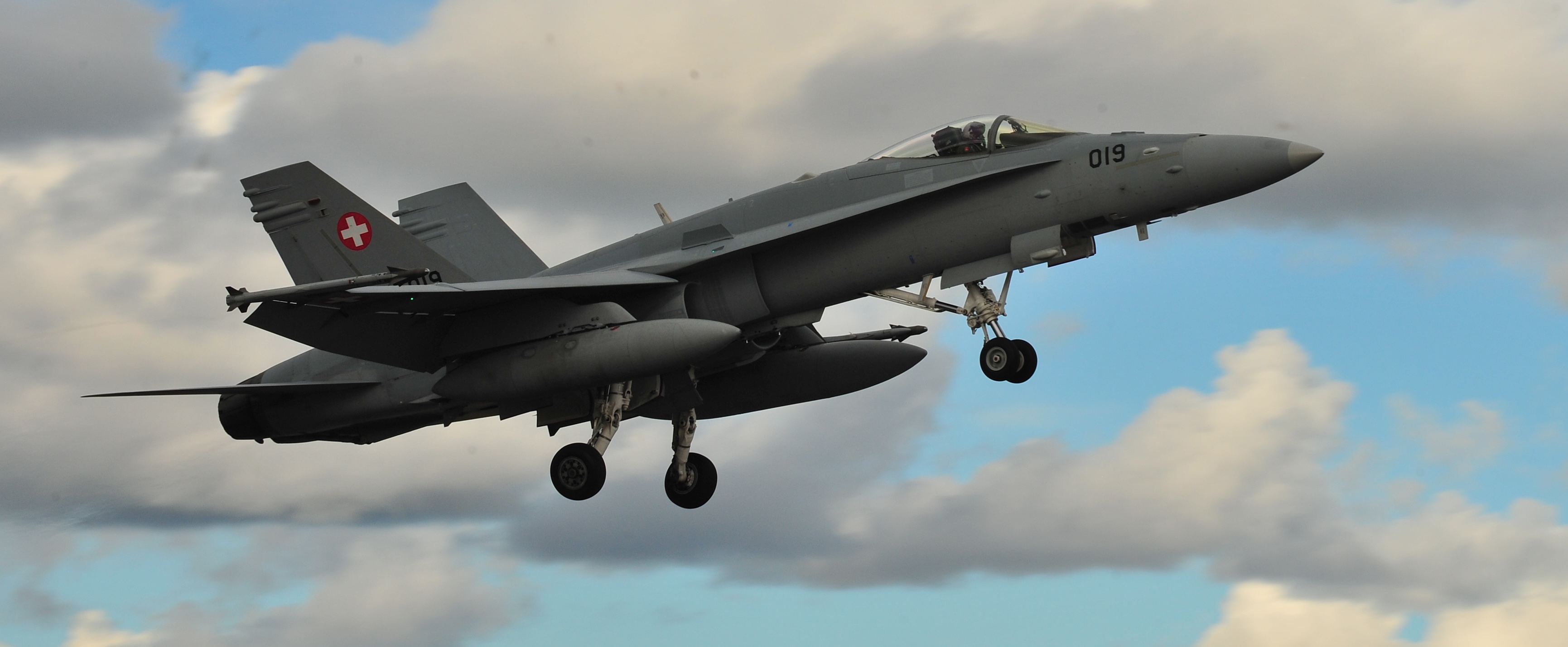 A Swiss air force F-18 Hornet takes off from the runway here Sept. 3, in support of the Nordic Air Meet 2012. The multinational training exercise brought together more than 50 aircraft from the United States, Great Britain, Denmark, Finland, Switzerland and Sweden to participate in tactical role-playing training missions. The three week exercise enabled the different nations to exchange aerial tactics and capabilities to improve combat power effectiveness in solo and joint environments while building and strengthening international partnerships. (U.S. Air Force Photo by Airman 1st Class Dillon Davis/Released)