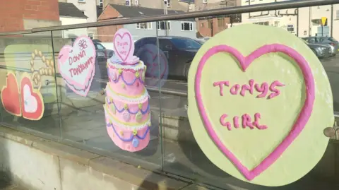 Paul Burnell/BBC Artwork replicating Love Hearts sweets on a glass panel in the street