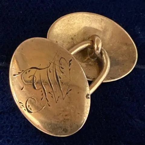 Portland Museum A single gold cufflink with the initials 'JW' engraved on it