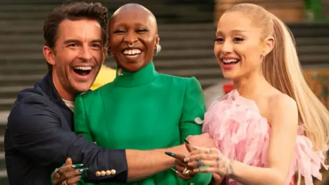Getty Images Wicked: For Good stars Jonathan Bailey, Cynthia Erivo, Ariana Grande laughing and hugging