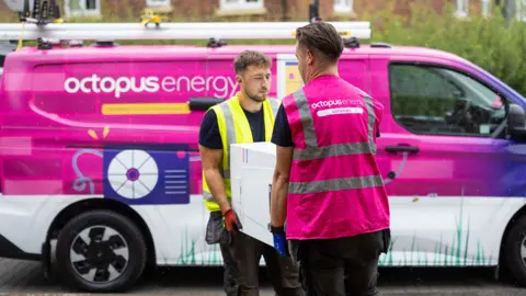Getty Images Octopus energy van and two Octopus energy employees carrying a boiler 