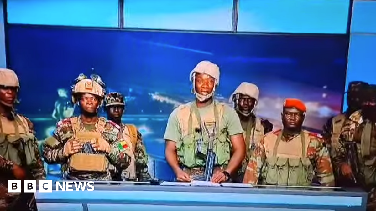Screengrab of soldiers talking on national TV in Benin. They are in fatigues, some with guns.