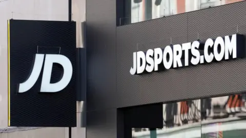 Reuters An exterior shop sign, black and white text reading JD, JDSports.com