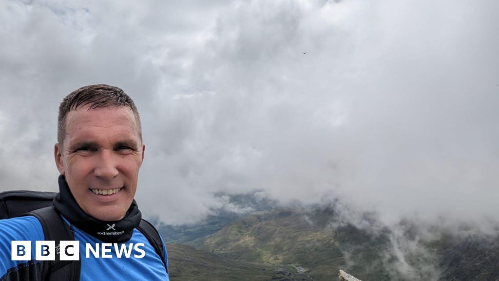 Cyclist eating Christmas dinner alone on Mount Snowdon