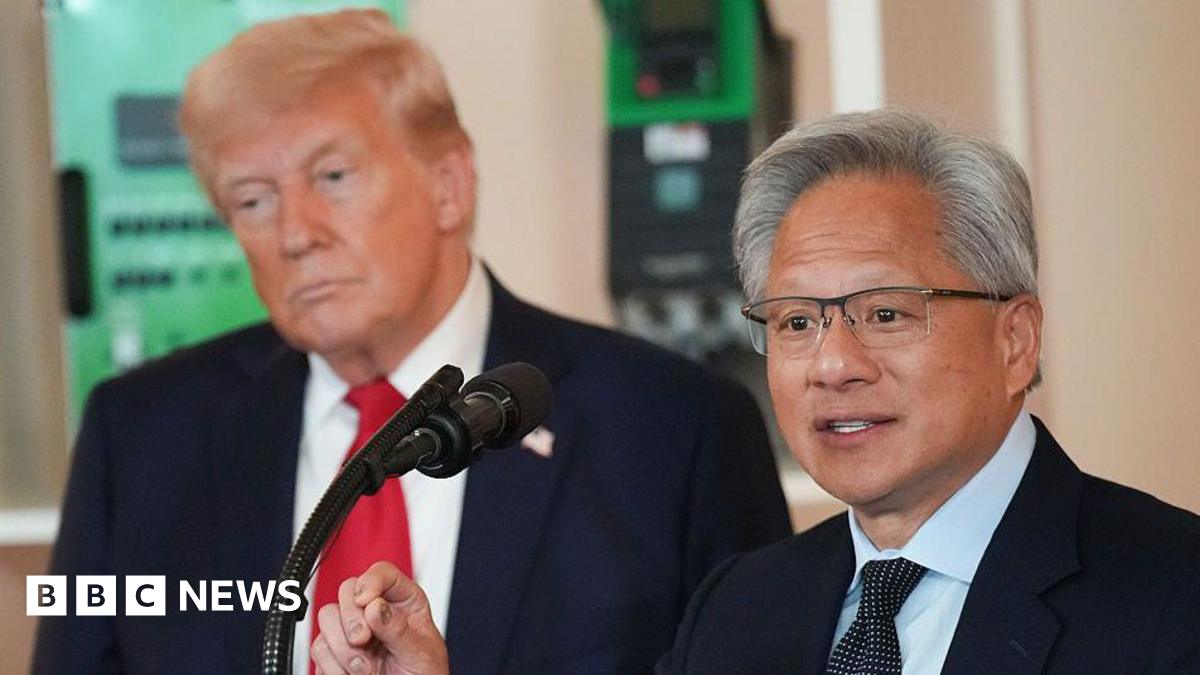 US President Donald Trump (L) listens as Nvidia CEO Jensen Huang speaks to an audience through a microphone in front of him