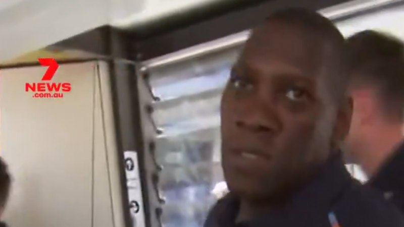 England team security guard clashes with a Seven Network cameraman at Brisbane Airport ahead of the third test against Australia