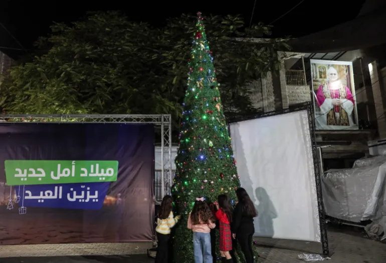 The Christmas tree is lit at the church in Gaza during prayers, with celebrations subdued due to the conditions in the Strip 
