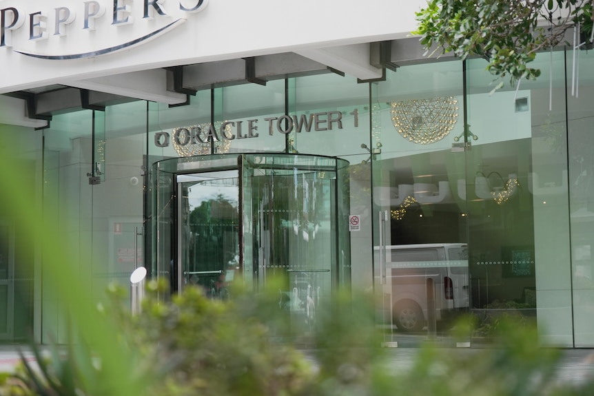 Close up of the front doors of the building with the sign Oracle Tower.