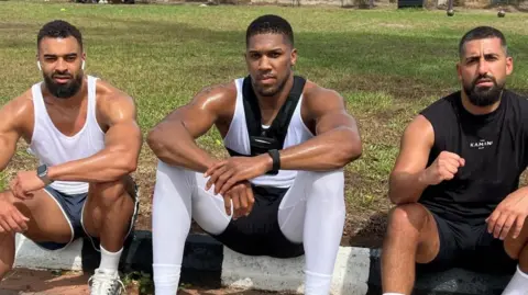 Social Media Latif "Latz" Ayodele, Anthony Joshua and Sina Ghami pictured outside in exercise gear