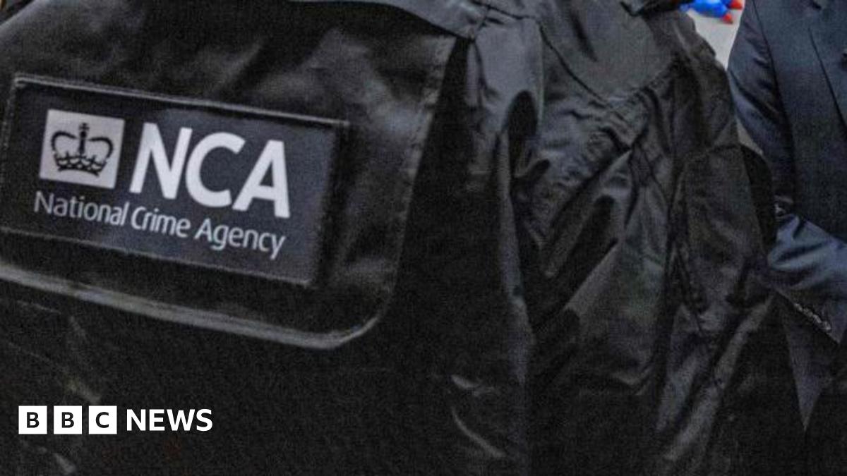 A black jacket with the letters NCA in white writing on the back and National Crime Agency underneath
