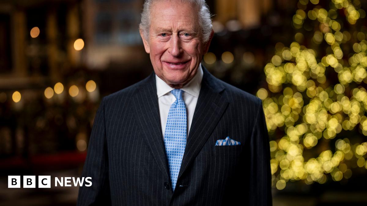 King Charles III in front of Christmas tree delivering speech in Westminster Abbey